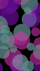 Multicolored translucent circles on a dark background. Vertical image orientation. 3D illustration