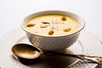 Kaddu or Pumpkin Kheer Or Bhoplyachi Kheer in Marathi and gummadikaya payasam in Telugu, Garnished with dry fruits. served in a bowl over moody background. Selective focus