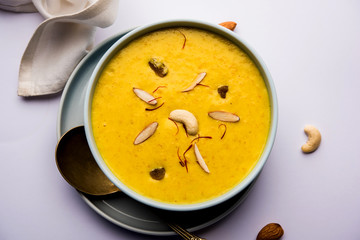 Kaddu or Pumpkin Kheer Or Bhoplyachi Kheer in Marathi and gummadikaya payasam in Telugu, Garnished with dry fruits. served in a bowl over moody background. Selective focus