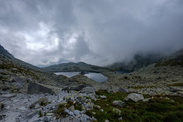 peak of Rysy mountain covered in mist. autumn ascent on hiking trails