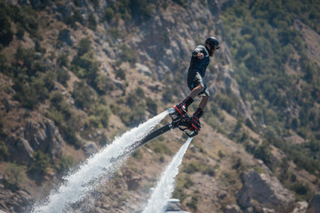 Obraz premium Flyboarding and seariding on the Sea near the mountain island. Water summer extreme sports.