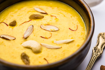 Kaddu or Pumpkin Kheer Or Bhoplyachi Kheer in Marathi and gummadikaya payasam in Telugu, Garnished with dry fruits. served in a bowl over moody background. Selective focus