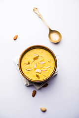 Kaddu or Pumpkin Kheer Or Bhoplyachi Kheer in Marathi and gummadikaya payasam in Telugu, Garnished with dry fruits. served in a bowl over moody background. Selective focus