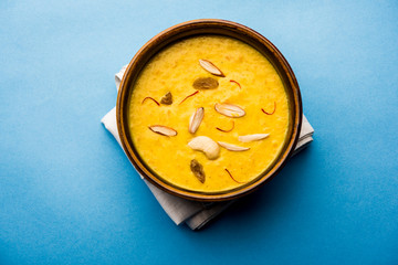 Kaddu or Pumpkin Kheer Or Bhoplyachi Kheer in Marathi and gummadikaya payasam in Telugu, Garnished with dry fruits. served in a bowl over moody background. Selective focus