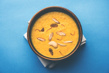 Kaddu or Pumpkin Kheer Or Bhoplyachi Kheer in Marathi and gummadikaya payasam in Telugu, Garnished with dry fruits. served in a bowl over moody background. Selective focus