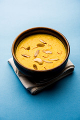 Kaddu or Pumpkin Kheer Or Bhoplyachi Kheer in Marathi and gummadikaya payasam in Telugu, Garnished with dry fruits. served in a bowl over moody background. Selective focus