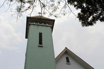 The architecture of the Catholic Church of Holy Cross (Salib Suci), including the tower
