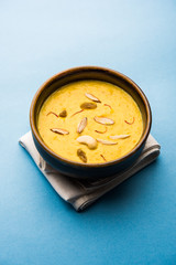 Kaddu or Pumpkin Kheer Or Bhoplyachi Kheer in Marathi and gummadikaya payasam in Telugu, Garnished with dry fruits. served in a bowl over moody background. Selective focus