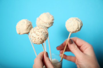 Cake pop, white chocolate ball dessert on stick.