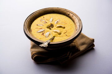 Kaddu or Pumpkin Kheer Or Bhoplyachi Kheer in Marathi and gummadikaya payasam in Telugu, Garnished with dry fruits. served in a bowl over moody background. Selective focus