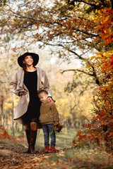 Fototapeta premium charming beautiful mother walks with little daughter girl