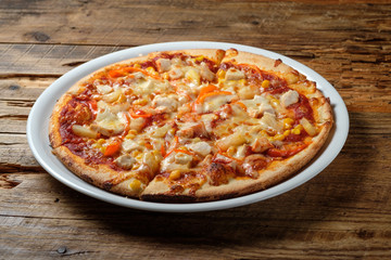 Pizza with chicken, corn and pineapple