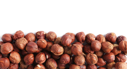 heap of hazelnut kernels isolated on white background