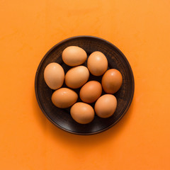 Egg, Chicken Eggs in plate on colored yellow background top view