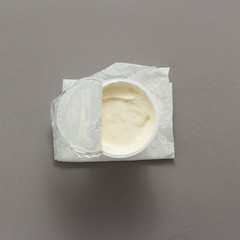 sour cream in bowl on grey background top view