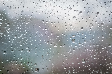 Naklejka na ściany i meble Rain drops on window glass. Abstract background texture. Selective focus