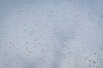 Rain drops on window glass. Abstract background texture. Selective focus