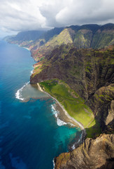 View of the monumental Na Pali Coast at Makuaiki Point and Kaahole Valley, aerial shot from a helicopter, Kauai, Hawaii.