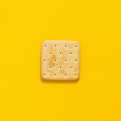 Tasty cookies biscuits on yellow colored background, top view