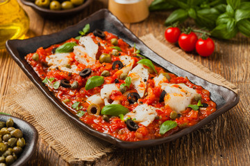 Cod in Italian in tomatoes with olives and capers.