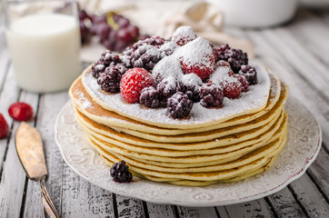 Homemade crepes with frozen berries, topped sugar