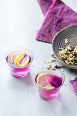 Purple butterfly pea flowers tea in a glass on table