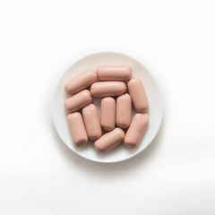 Raw sausages on white background, top view, flat lay