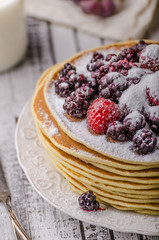 Homemade crepes with frozen berries, topped sugar