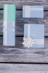 Festive gift boxes on wooden background. Beautiful Christmas presents and copy space. Happy Birthday card.