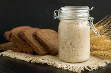 Active rye sourdough in a glass jar for homemade bread.