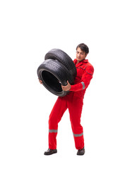 Young garage worker with tyre isolated on white