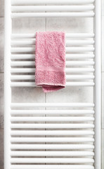 Pink towel on heater