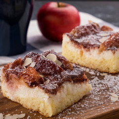 Homemade apple pie slice with  almond flakes and icing sugar
