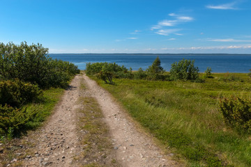 Fototapeta na wymiar Rural road - the gauge goes along the White Sea on Anzersky Island