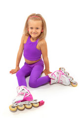 Girl, kid posing in studio wearing inline rollerskates