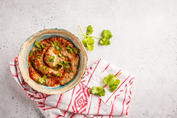 Middle Eastern cuisine: baba ganoush  in a plate on white background.