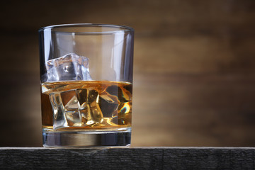 Glass with whiskey and ice cubes