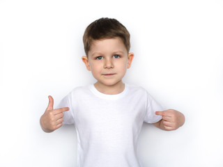 t-shirt design concept - smiling little boy in blank white t-shirt pointing at herself