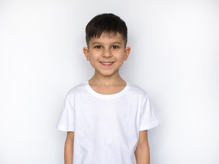 little smiling boy in white t-shirt isolated on white