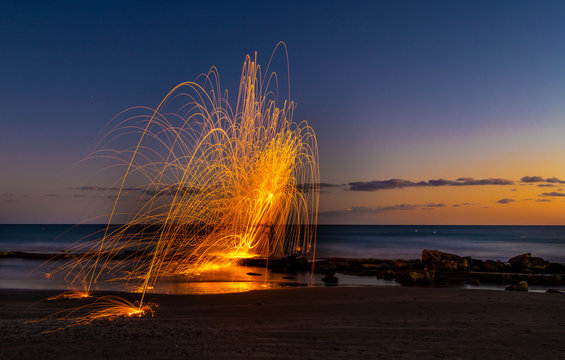 Steel wool photography at a rocky beach