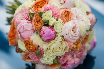 Wedding beautiful bridal bouquet of natural flowers, closeup with blurred background