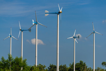 Fototapeta premium Windmills for electric power production in Royal Initiative Project Chang Hua Mun project demonstrate holistic agriculture for sufficient economy at Hua Hin district Phetchaburi, Thailand