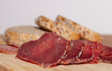 Ham. Sausage. Wooden. Meat. Smoked. Bread. Grains