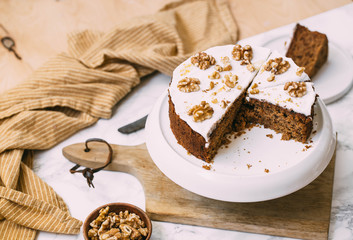 Carrot Cake with Cream Cheese Icing and walnut. Vegan and gluten free concept