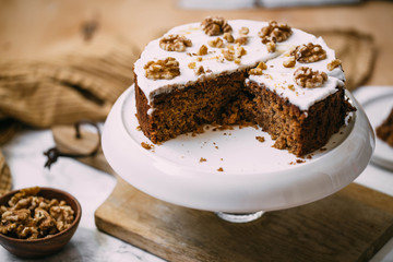Carrot Cake with Cream Cheese Icing and walnut. Vegan and gluten free concept