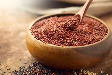 Quinoa. Red, black and white quinoa grains in a wooden bowl. Healthy food. Chenopodium quinoa