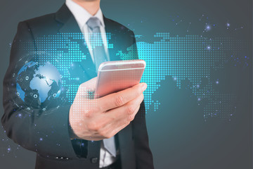 Double exposure of Businessman use smartphone and global networking and world map mesh as business, technology, communication and innovation concept.