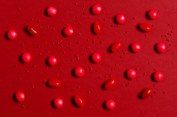 Pattern of red candy on the red background