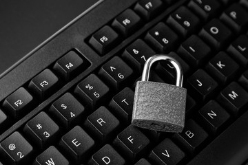 Cyber security concept image consisting of a padlock on a computer keyboard. 