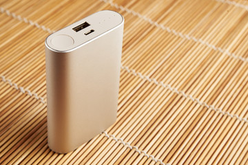 gray powerbank on wooden background